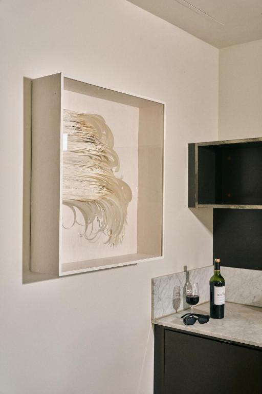 a kitchen with a painting hanging on the wall at STILE Downtown Los Angeles by Kasa in Los Angeles