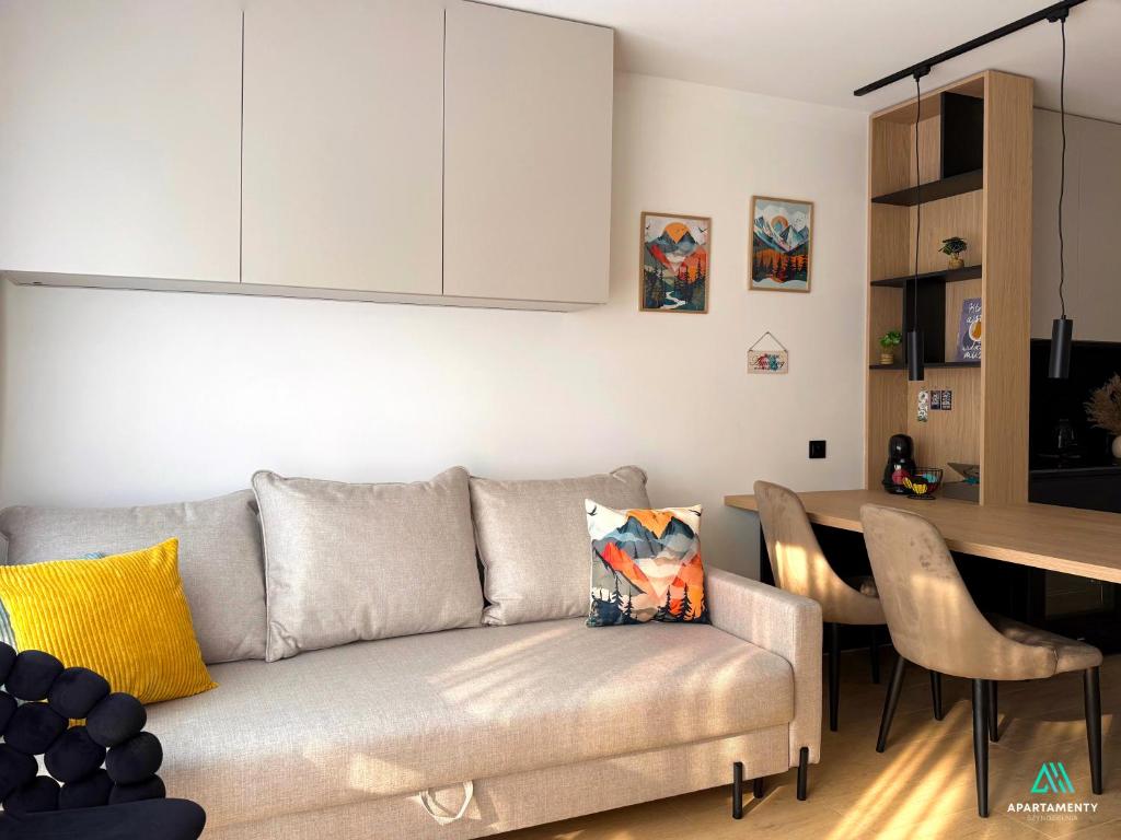 ein Wohnzimmer mit Sofa und Tisch in der Unterkunft APARTAMENTY SZYNDZIELNIA 2 POKOJE & BALKON & PARKING & ROWEROWNIA WORKATION Home OFFICE - NOWA NAJLEPSZA BAZA WYPADOWA W BESKIDY in Bielsko-Biała