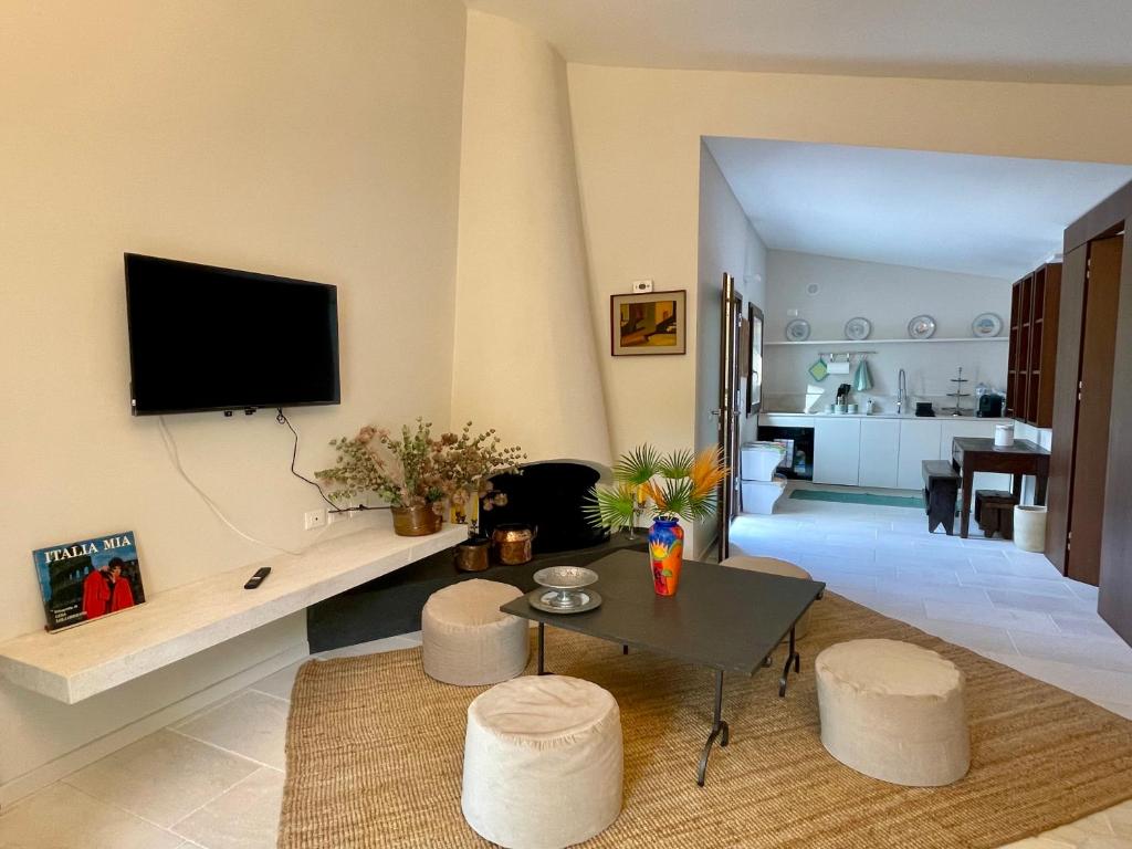 a living room with a table and two stools at La Casetta Colonica in Cefalù