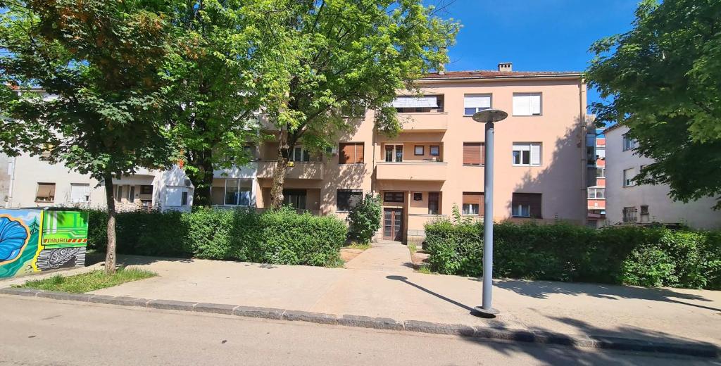 a pole on the sidewalk in front of a building at CityHeart Apartment in Nikšić