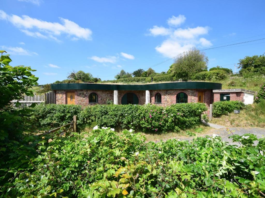 an old brick building with a green roof at 2 Bed in Westward Ho 77292 in Bideford