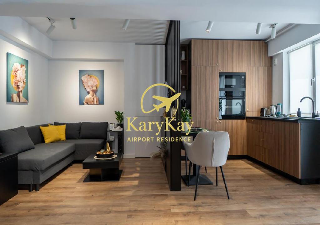 a living room with a couch and a kitchen at Otopeni KaryKay Airport Residence in Otopeni