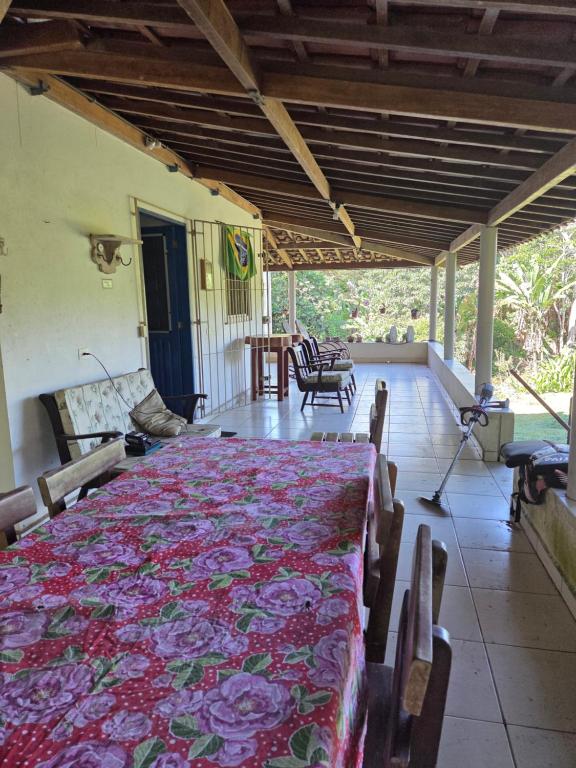 a large room with a table with a blanket on it at Pousada Sítio do Engenho in Escada