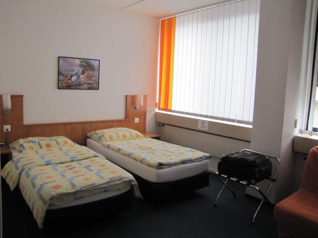 Postel nebo postele na pokoji v ubytování Budget Motel Self Check-In