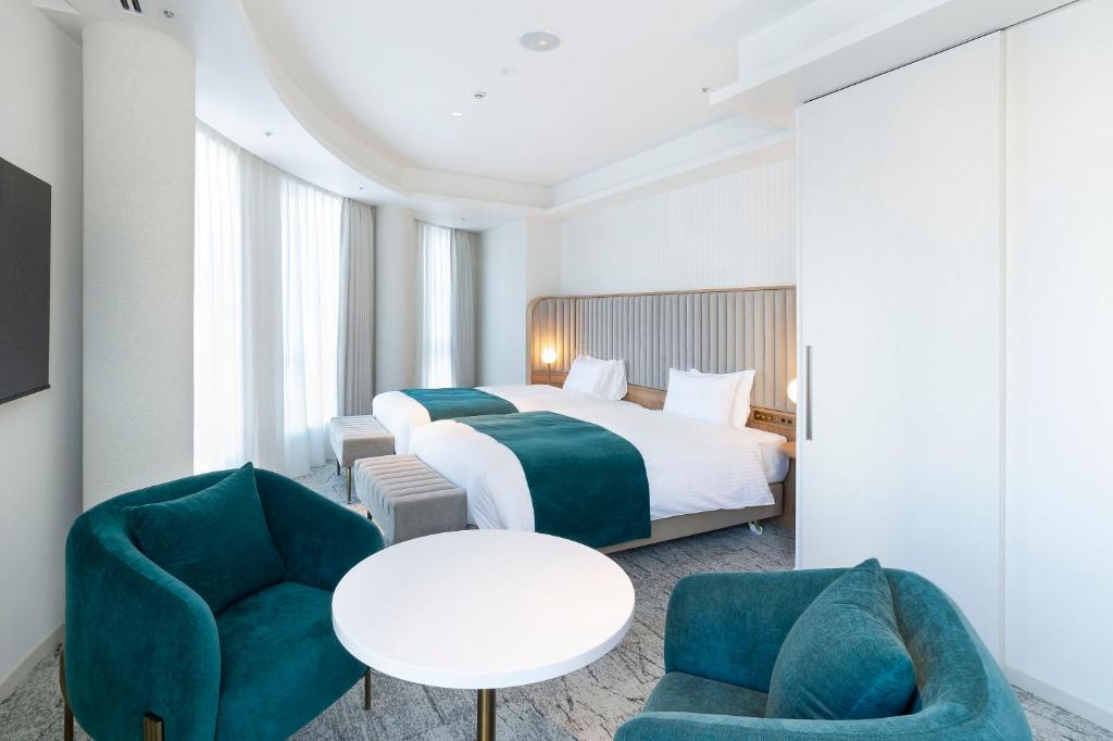 Postel nebo postele na pokoji v ubytování Hotel Comento Yokohama Kannai