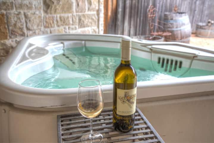 a bottle of wine and a glass next to a hot tub at New Pool, Patio, Pickleball, Cornhole, Hot Tub in Fredericksburg