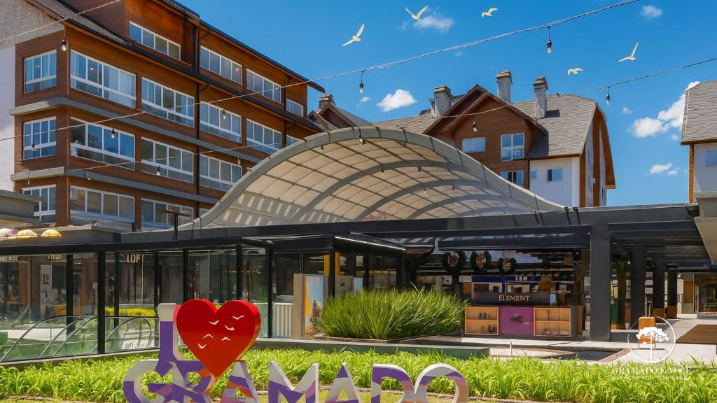 a rendering of the entrance to a building with a red heart at Modern apt next to Criamigos Park + coffee Day 1 in Gramado