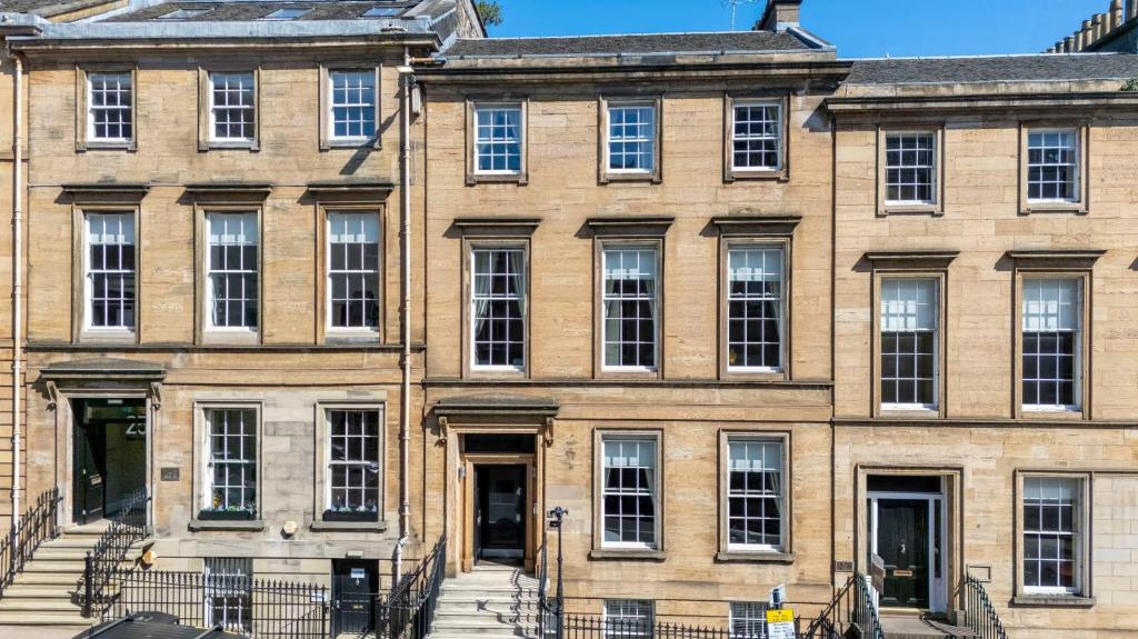 a large brick building with stairs in front of it at Blythswood Apartments - Experience Luxury Living in Glasgow