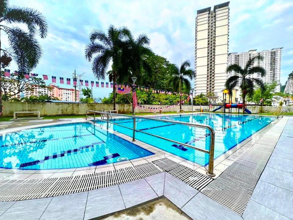 a large swimming pool with blue water at Angsana Raintree Batu Caves with balcony 3Bedroom 2Bathroom in Batu Caves