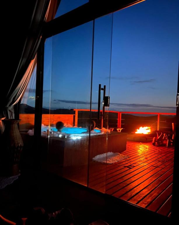 a view of the deck of a cruise ship at night at Cabana Alpina Ibitipoca in Conceição da Ibitipoca