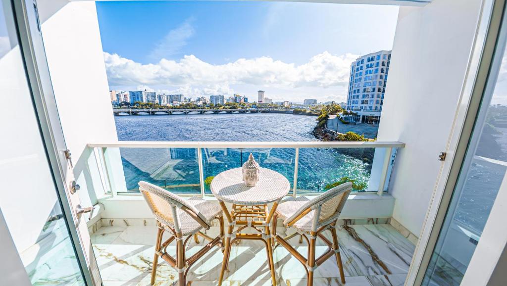 a balcony with a table and chairs and a view of the water at Top Favorite Studio by The BEACH in San Juan