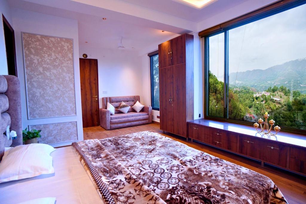 a large bedroom with a large window and a couch at Hill Crest By Xaria Luxury Homes 2BHK Apartment in Dharampur