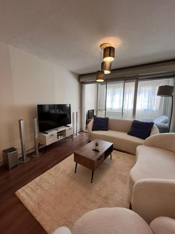 a living room with a couch and a table at Zamalek Jedda tower 3BR in Cairo