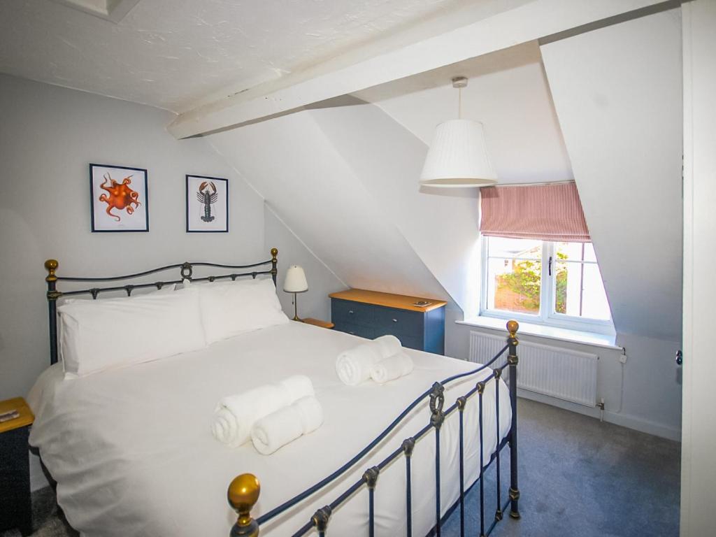 a bedroom with a bed with towels on it at Wherry Cottage in Wells next the Sea