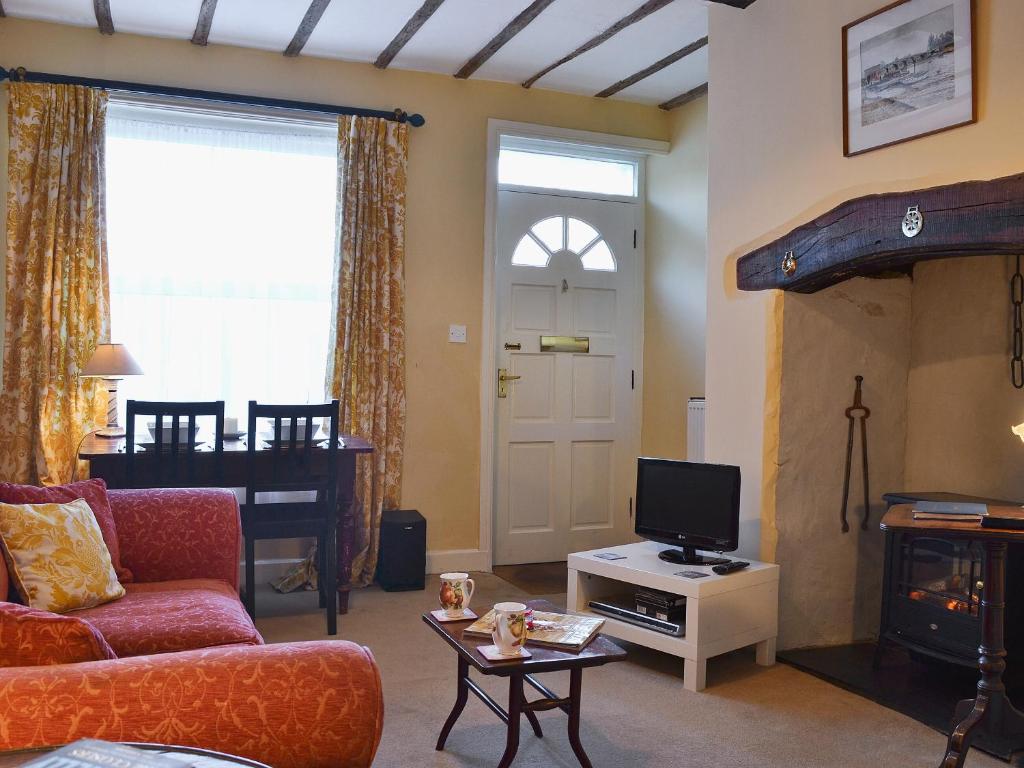 a living room with a couch and a tv at Church Lane in Llanidloes
