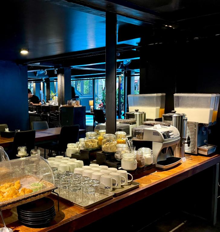 A drinks and cereal section of the breakfast buffet with coffee equipment.