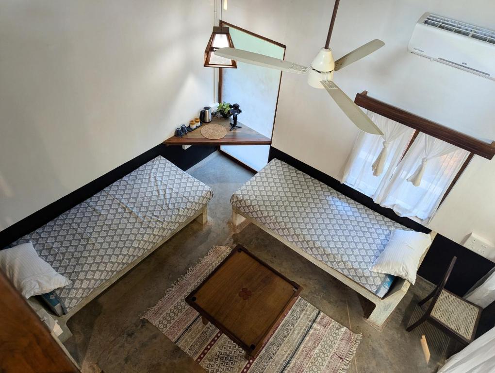 an overhead view of a living room with two chairs and a table at Svarna in Udupi
