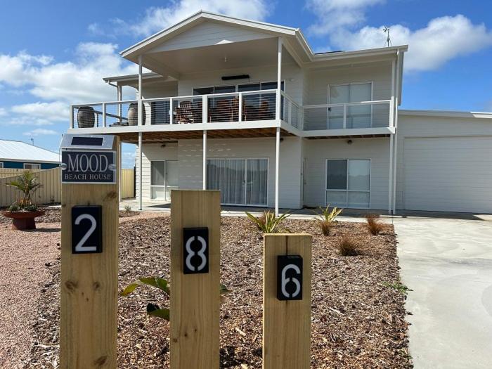 a house with two signs in front of it at Mood Beach House - Moonta Bay in Port Moonta