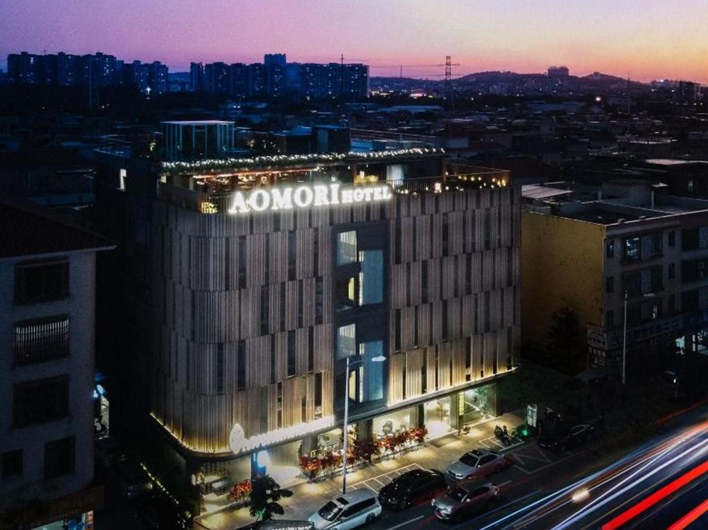 a large building with a sign on the side of it at Aomori Hotel -Foshan Shunde Qinghui Garden Resort OCT Harbour PLUS Branch in Shunde
