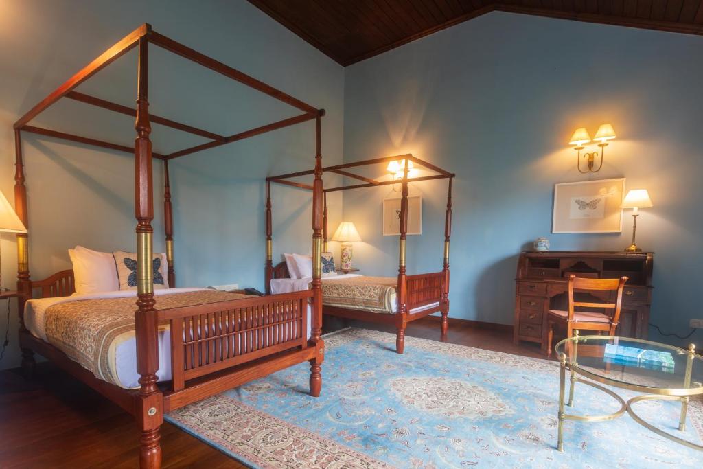 Postel nebo postele na pokoji v ubytování Kandy Dendrobium House