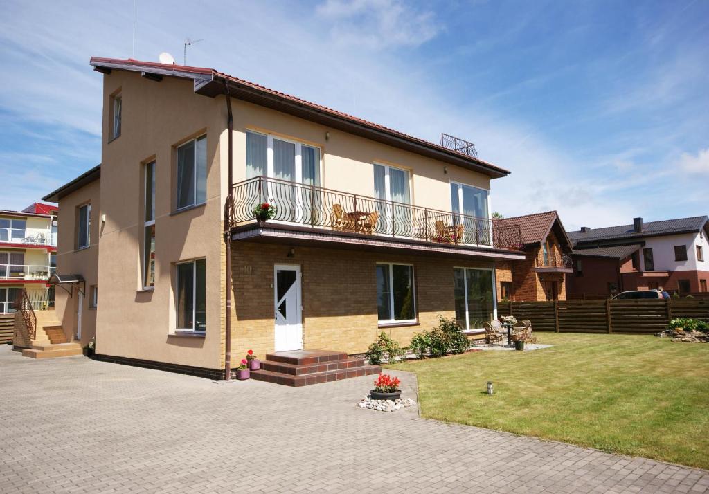 een groot huis met een balkon en een tuin bij Smilga in Palanga