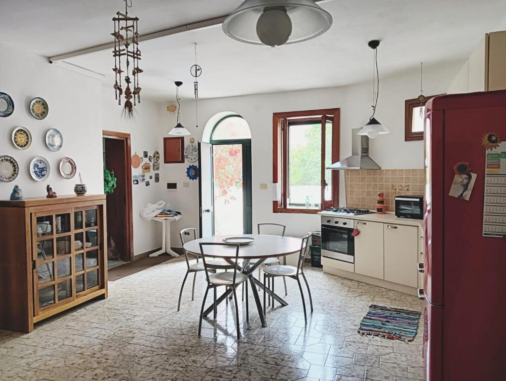 a kitchen with a table and chairs in a room at Happy House Corricella in Procida