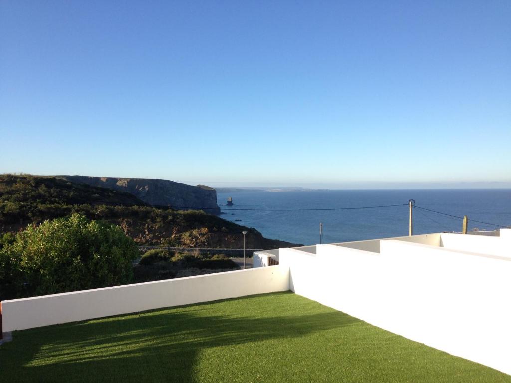 a view of the ocean from the balcony of a house at Casa Trinta - Praia da Arrifana in Praia da Arrifana