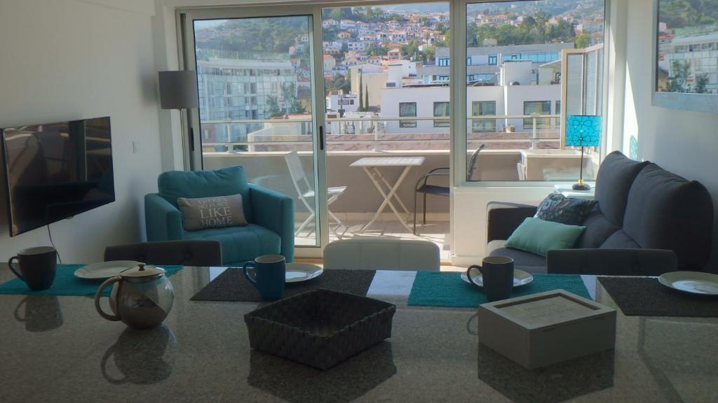 a living room with a view of a city at Arriaga apartment in Funchal