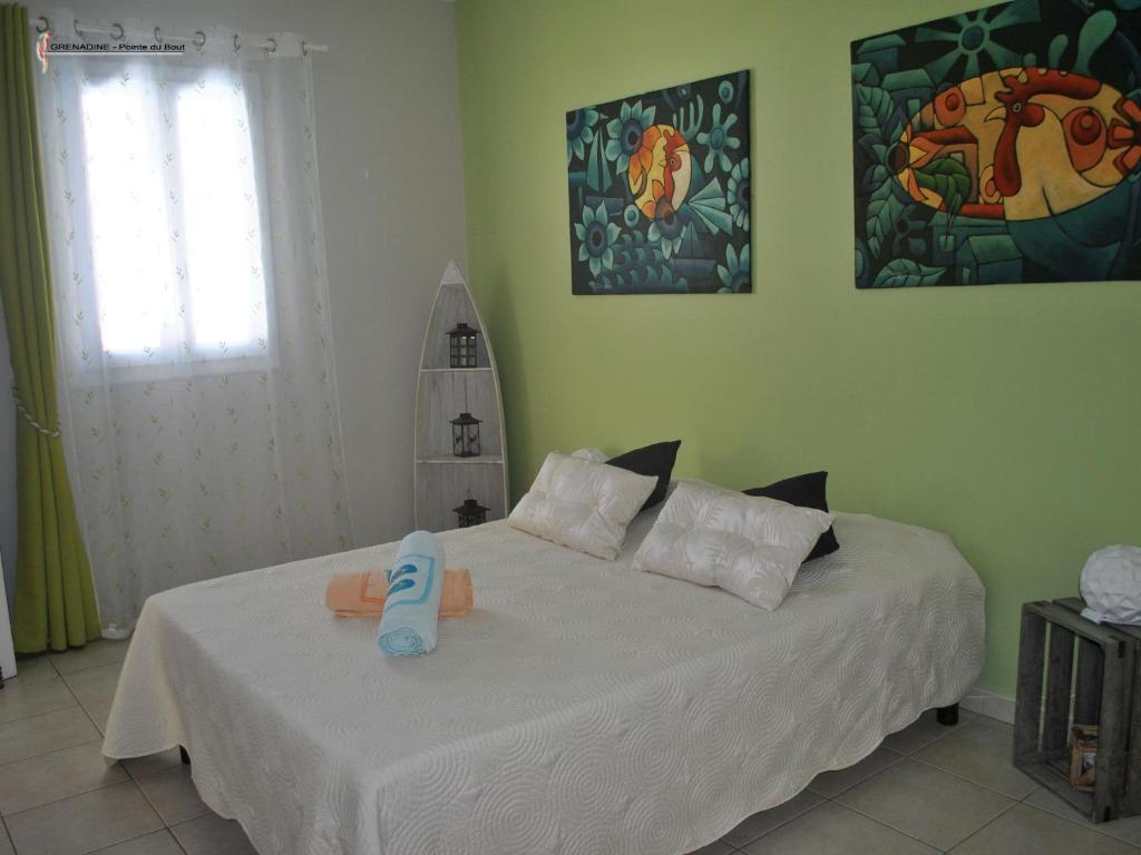 a bedroom with a bed with a pacifier on it at CoCoKreyol - " GRENADINE " in Les Trois-Îlets