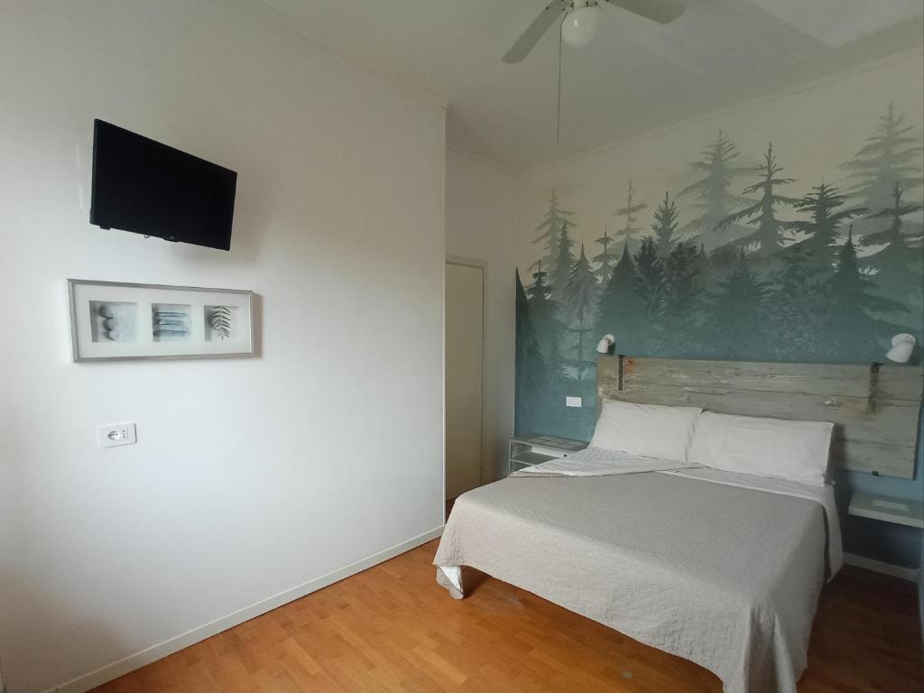 a bedroom with a bed and a tv on the wall at Casa Vintago b&b in Savio di Ravenna