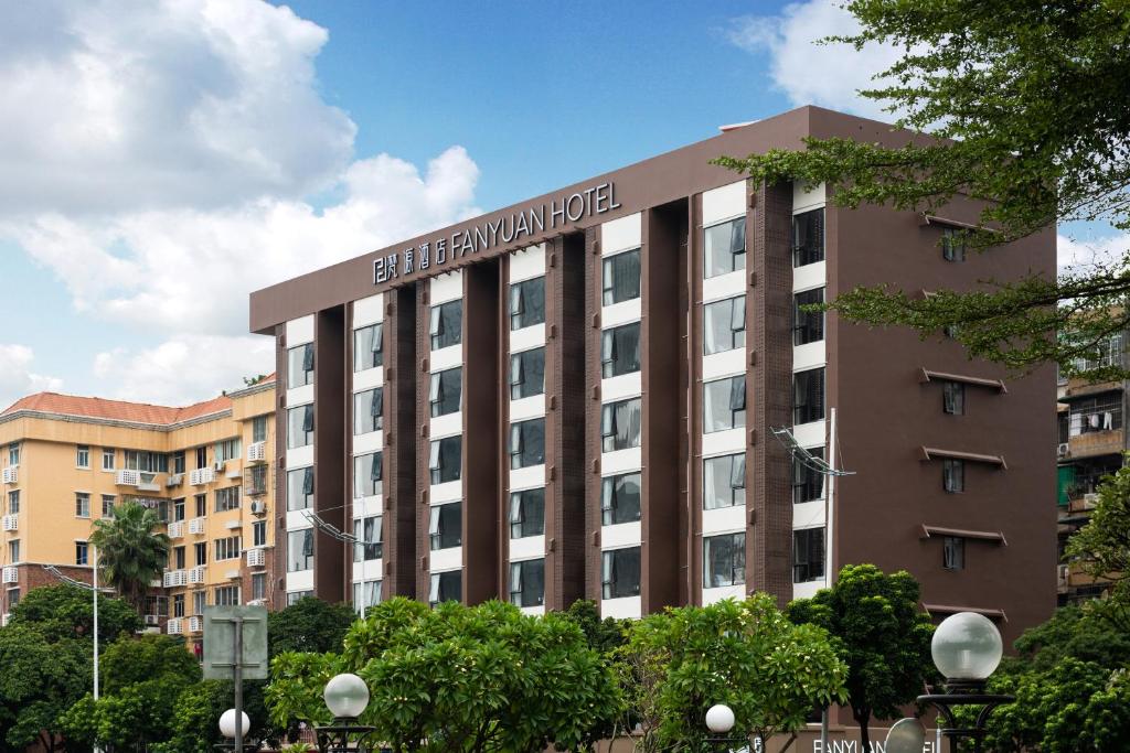 a large building with a sign on top of it at Fanyuan Hotel Zhujiang New City Guangzhou in Guangzhou