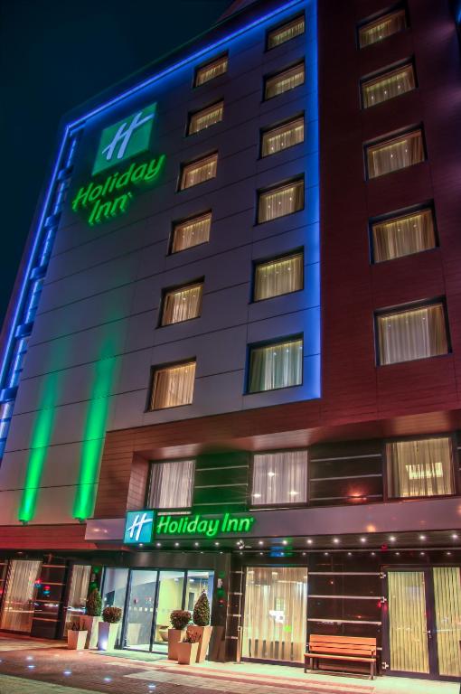 a hotel building with a happy hour sign on it at Holiday Inn Plovdiv by IHG in Plovdiv