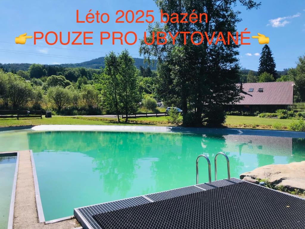a swimming pool in a villa with a view at Penzion a apartmány Skipark Hraběšice in Krásné