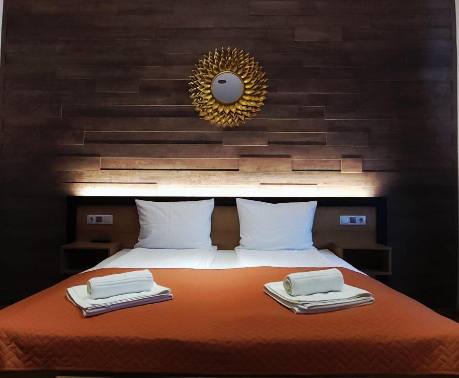 a bedroom with a bed with two towels on it at 4Rooms Central Sibiu in Sibiu