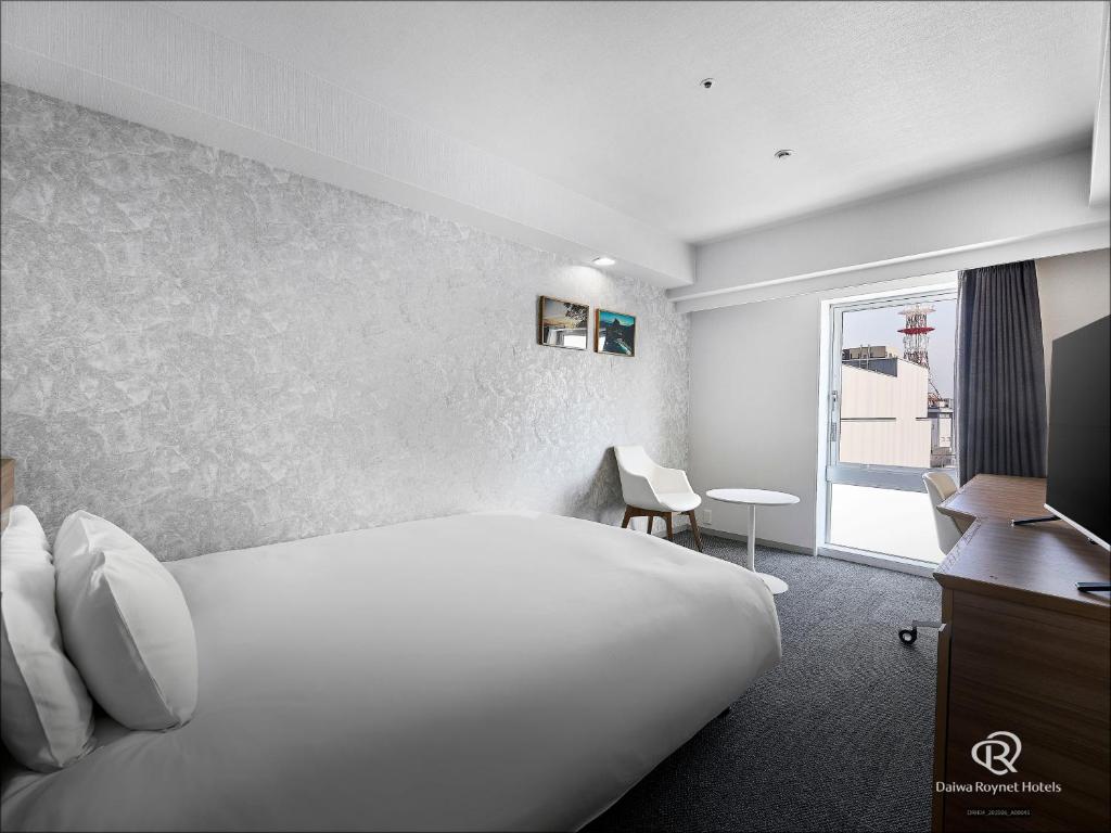 Postel nebo postele na pokoji v ubytování Daiwa Roynet Hotel Numazu