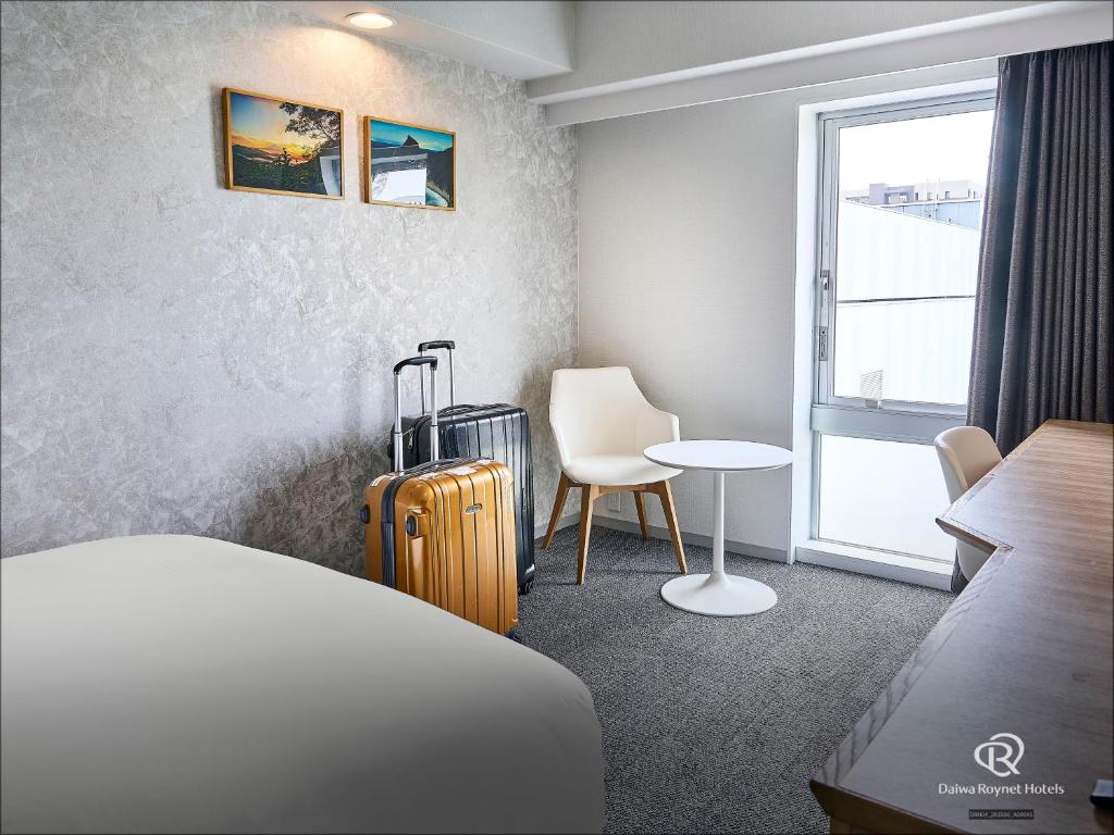 Postel nebo postele na pokoji v ubytování Daiwa Roynet Hotel Numazu