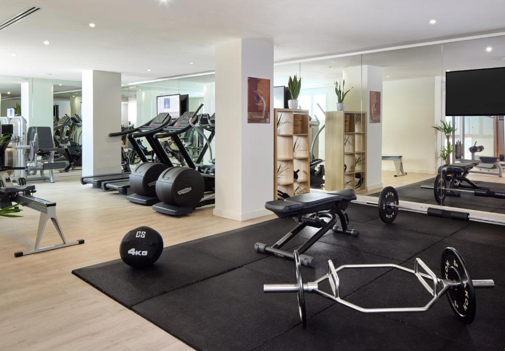 a gym with a lot of treadmills and machines at Meliá Cala Galdana in Cala Galdana