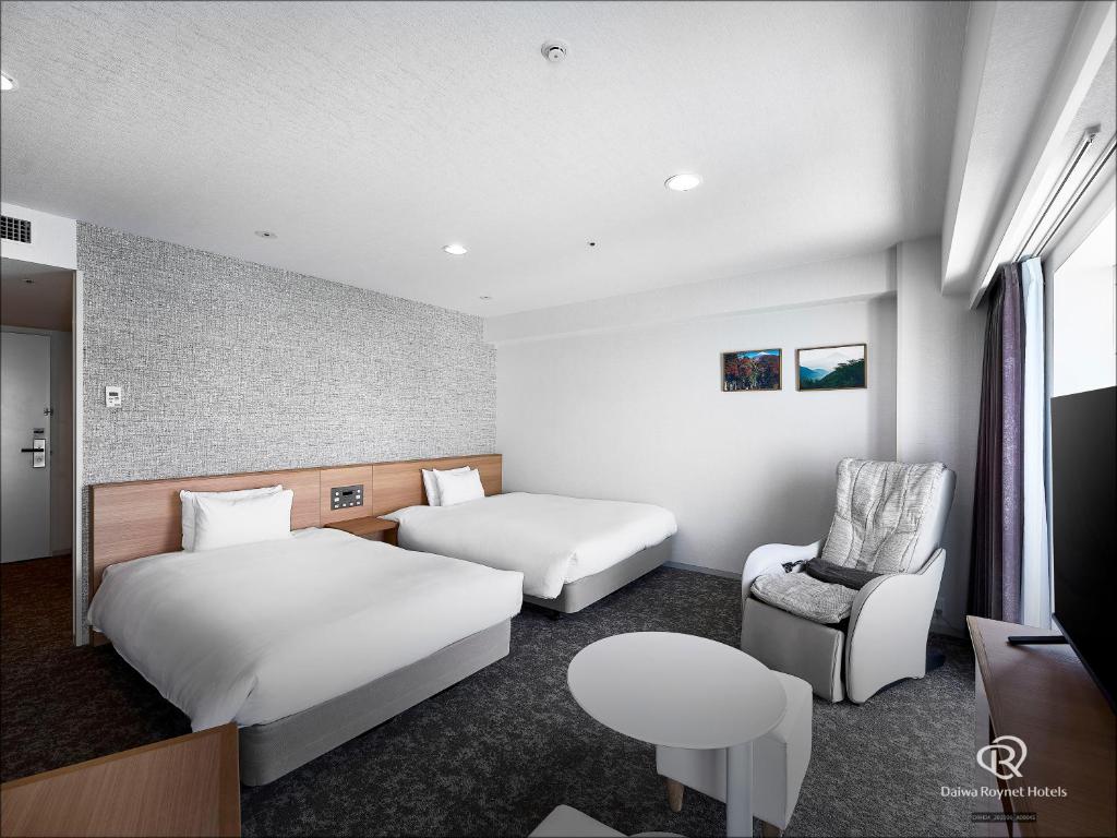 Postel nebo postele na pokoji v ubytování Daiwa Roynet Hotel Numazu