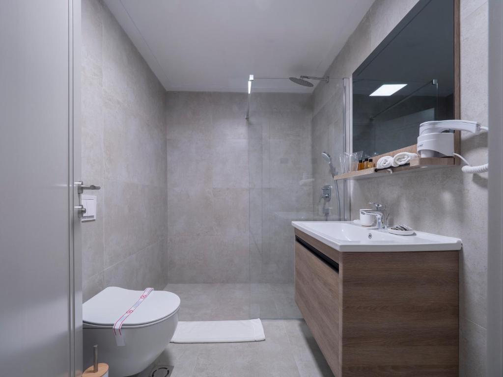a bathroom with a shower and a toilet and a sink at CASA AL MARE RESIDENCE in Bečići