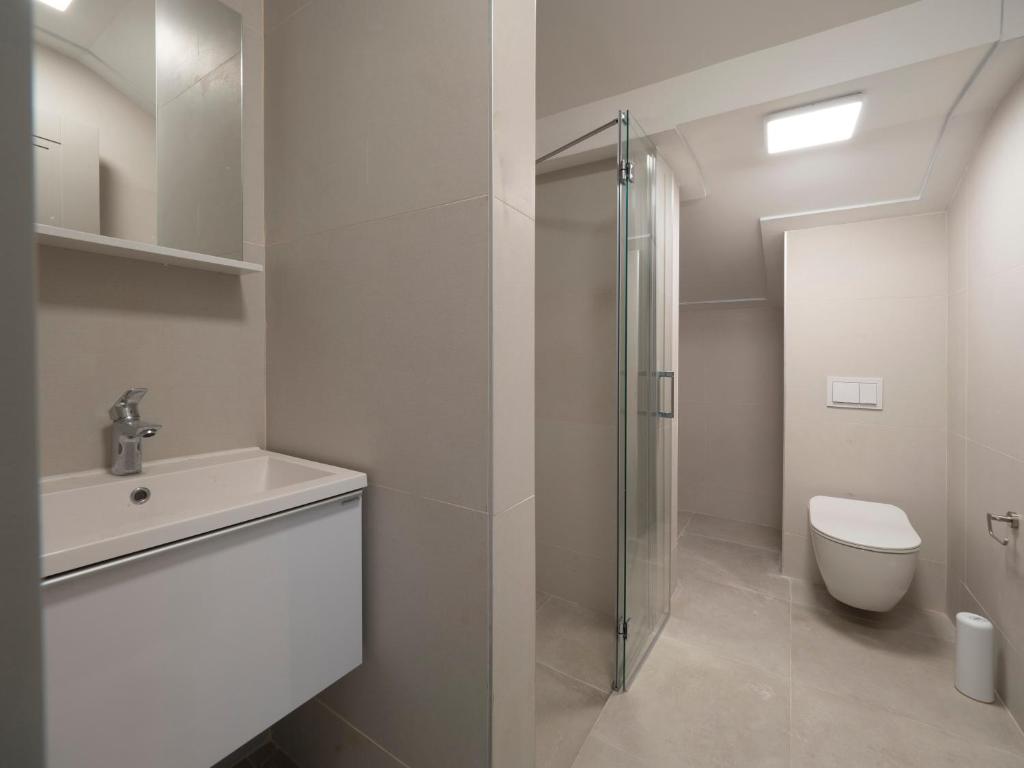 a bathroom with a toilet and a sink and a shower at CASA AL MARE RESIDENCE in Bečići