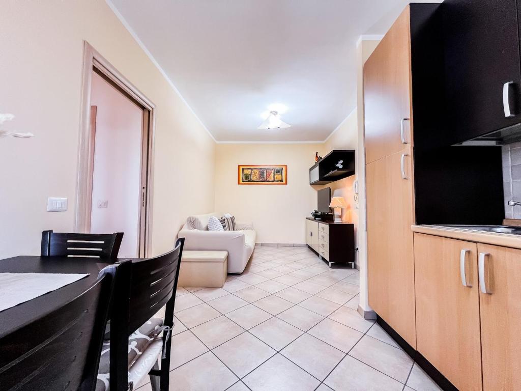 a room with a kitchen and a living room at Ginestra house in Olbia