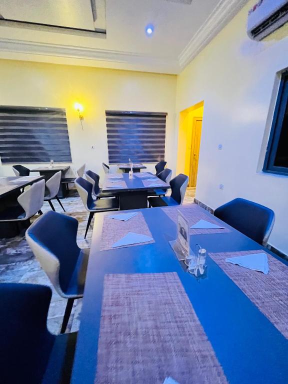 a conference room with tables and chairs in a room at Global Suites in Kano