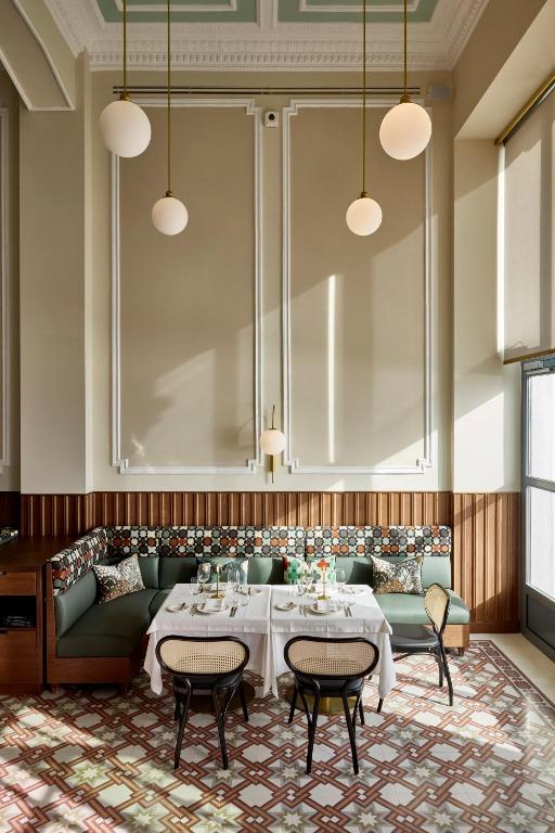 a dining room with a couch and a table at ON Residence - Small Luxury Hotels of the World in Thessaloniki