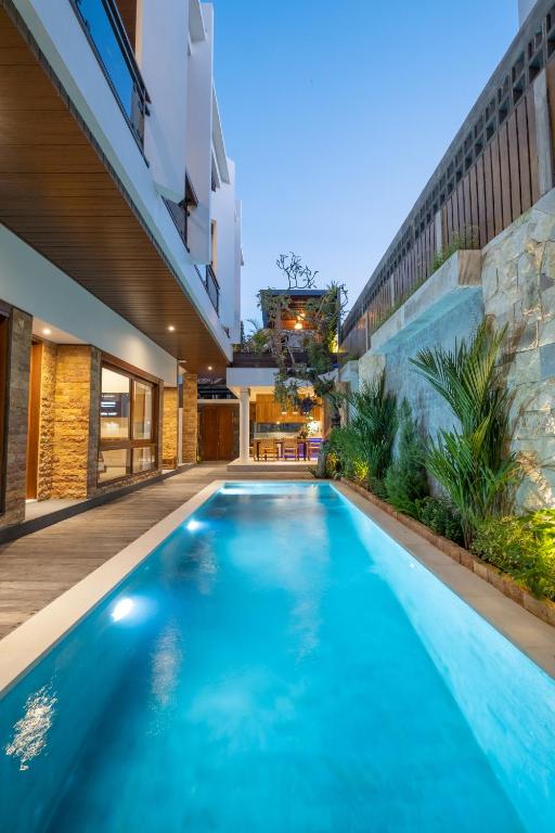 a swimming pool in the backyard of a house at Joon Canggu Apartment in Canggu