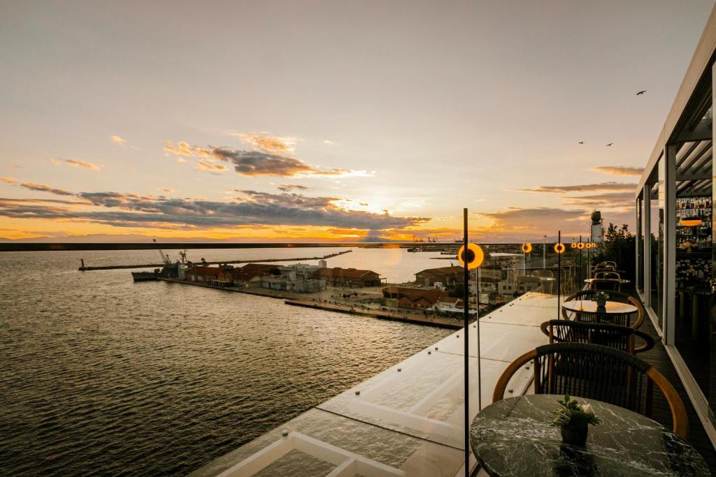 a view of a body of water with a sunset at ON Residence - Small Luxury Hotels of the World in Thessaloniki
