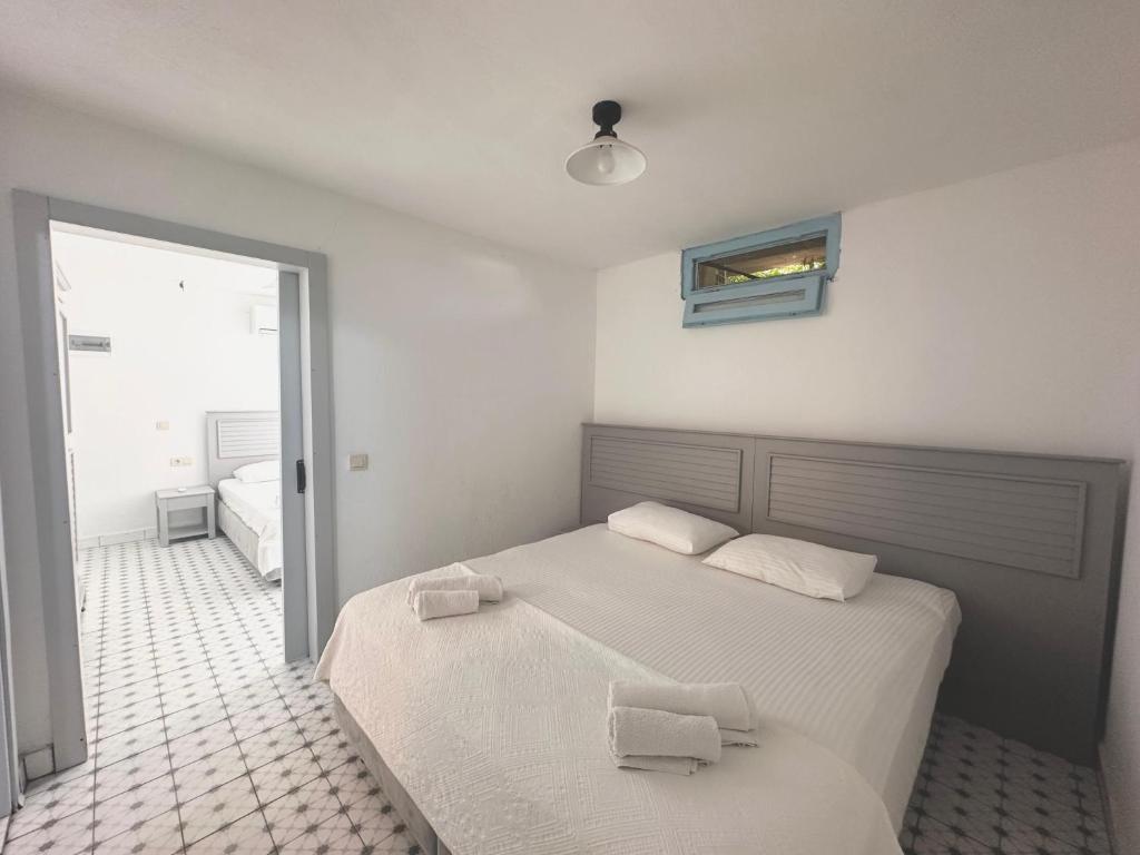 Postel nebo postele na pokoji v ubytování Dort Mevsim Alacati