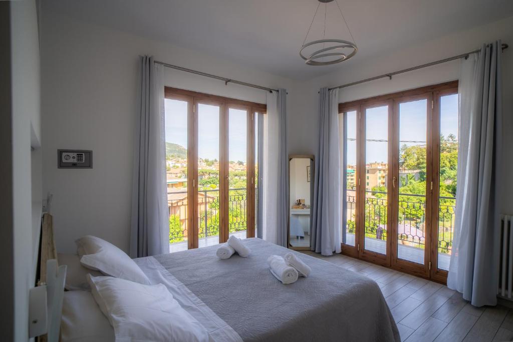 a bedroom with a bed with two towels on it at Villa Mafalda in Pietra Ligure