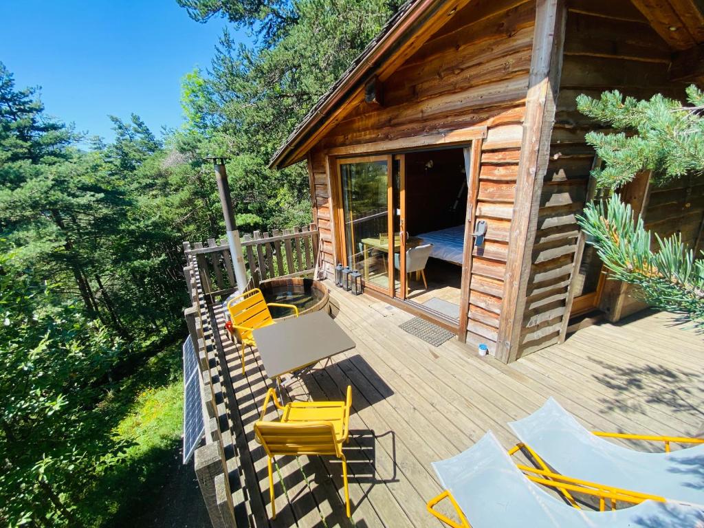 an overhead view of a cabin with a deck with yellow chairs at Là-Haut cabanes perchées in La Thuile