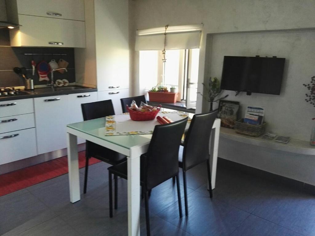 a kitchen and dining room with a table and chairs at Monica & Rocco's House in Venaria Reale