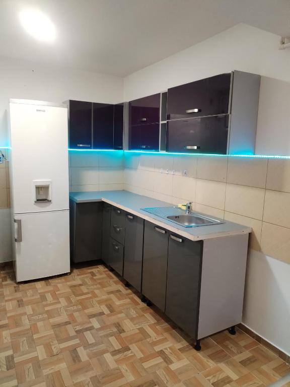 an empty kitchen with a sink and a refrigerator at Zețarilor 21A in Bucharest